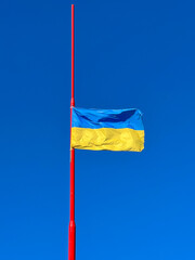 Blue and yellow flag of Ukraine against the clear sky - Stand with Ukraine
