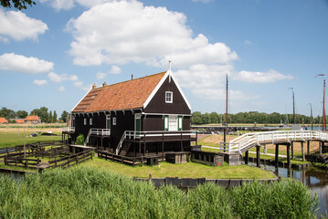 Enkhuizen, Netherlands. June 2022. Fisherman's cottage at the harbour with traditional fishing boats in Enkhuizen.