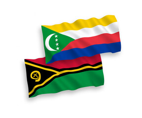 National vector fabric wave flags of Union of the Comoros and Republic of Vanuatu isolated on white background. 1 to 2 proportion.