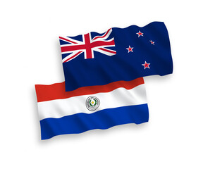 National vector fabric wave flags of New Zealand and Paraguay isolated on white background. 1 to 2 proportion.