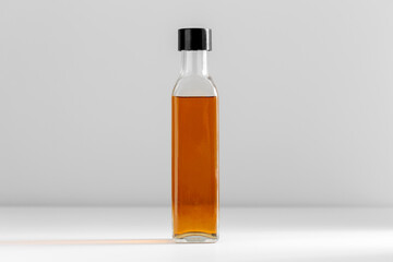 healthy eating, food and culinary concept - close up of olive oil in glass bottle on table