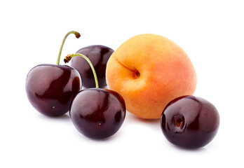 Sweet cherries with apricot isolated on white background cutout. Ripe berries closeup. Mix berries and fruits.