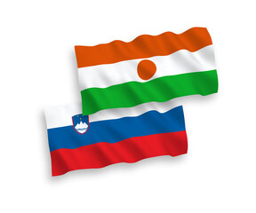 National vector fabric wave flags of Slovenia and Republic of the Niger isolated on white background. 1 to 2 proportion.