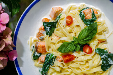 Spaghetti with basil, salmon, spinach and sauce