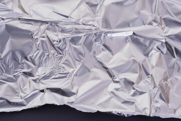 Aluminum food baking foil, wrinkled silver metallic background, texture
