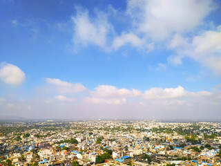 Beautiful view of the city on blue sky with clouds background
