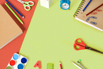 Colorful school supplies on light green background. Many Office Stationery Items flat lay. Back to school concept. College tools props accessories. Lime Nouveau trendy color. Top view, copy space