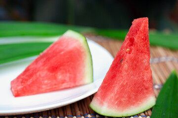 watermelon slice.Many big sweet green watermelons and one cut watermelon