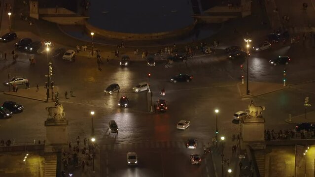 Cars driving on the Place de Varsovie square near the Trocadero at night in Paris, France