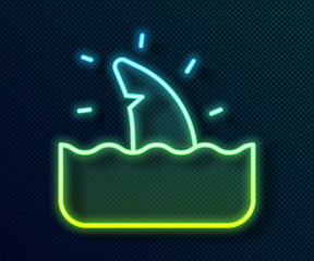Glowing neon line Shark fin in ocean wave icon isolated on black background. Vector