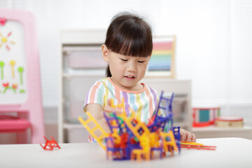 young girl playing balance chairs  toy for homeschooling