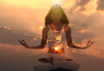 Young meditation woman feeling free on nature at sunrise. - obrazy, fototapety, plakaty