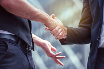 Businessman shaking hands on successful business deal.