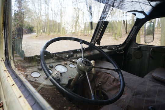 Cabin view of old soviet green army truck, abandoned in forest