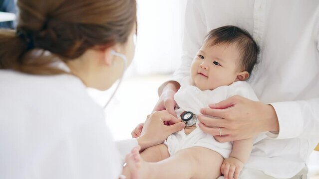 赤ちゃんを診察する女性医師　小児科医　乳幼児検診