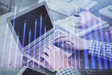 Double exposure of forex chart with man working on computer on background. Concept of market analysis.