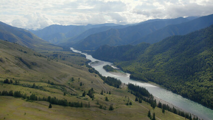 River Katun between green mountains of Ak-Kem valley under white clouds and blue sky