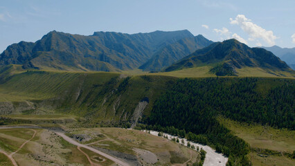 Fototapeta na wymiar Green mountains of Altai and river under clear blue sky