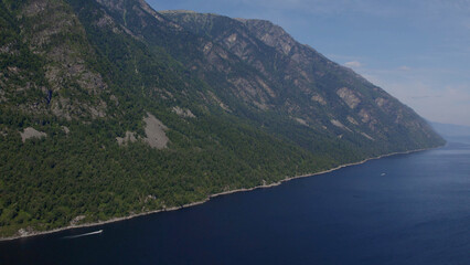 Lake Teletskoye between mountains with blue clear sky in Altai