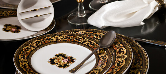 White premium porcelain tableware plates ready for dinner. Elegant table setting at home or restaurant with luxury dinnerware