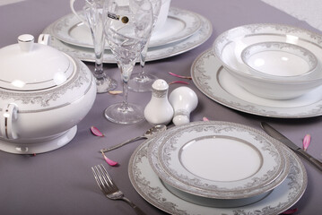 White premium porcelain tableware plates ready for dinner. Elegant table setting at home or restaurant with luxury dinnerware