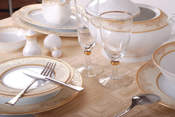 Elegant table setting with luxury china dinnerware. Golden design porcelain dishes.