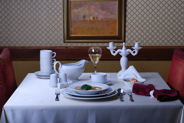 Elegant table setting with luxury china dinnerware. Golden design porcelain dishes.