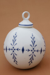 Porcelain globe for decorating the Christmas tree. Winter Holiday and Xmas ornament.