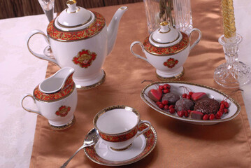 Beautiful bone-china tea set with tea pot and cups and saucers. Minimal and elegant design.