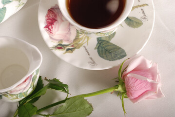 Beautiful bone-china tea set with tea pot and cups and saucers. Minimal and elegant design.