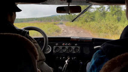 View from the cab of the car to forest in Altai