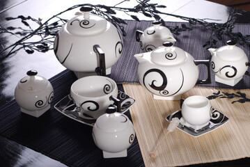 Beautiful bone-china tea set with tea pot and cups and saucers Elegant and minimal design.