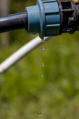 Drops of water falling from the pipe.