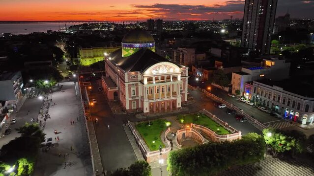 Colorful sunset sky over medieval building at cityscape downtown Manaus Brazil near Amazon river and Amazon Forest. Travel destinations. Sunset skyline. Sunset coastal city at Manaus Brazil.
