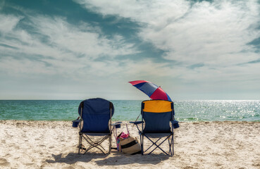 Sunset at white sand beach. Lounge beach chairs with accessory in Naples Beach, Florida, USA. Vintage processed.  - obrazy, fototapety, plakaty