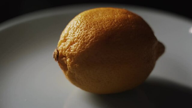 Fresh spinning lemons on black background.Lemon Tasty lemons isolate on the black background close up 4k