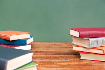 stacks of books lie on a wooden table close-up