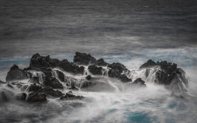 Porto Moniz - Long exposure of rocks and waves at vulcanic coast - beautiful landscape scenery of Madeira Island, Portugal. October 2021