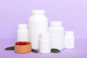 different drugs and health supplement pills with medicine bottle health care and medical top view. Vitamin tablets. Bottle with colored pills on table background. Multivitamins