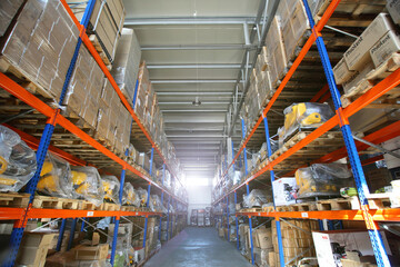 Warehouse store stock. Industrial warehouse. Warehouse of a trade organization. Goods and materials arranged on a rack in warehouse.