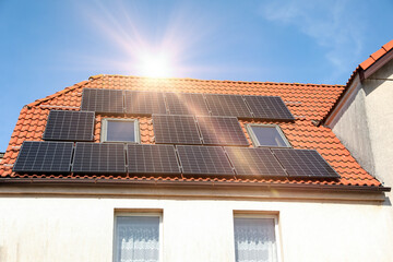 House with installed solar panels on roof. Alternative energy
