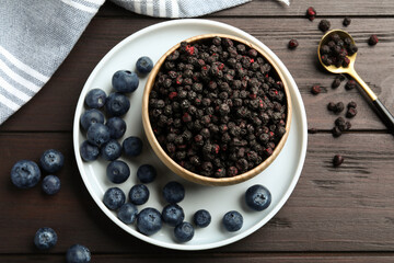 Fototapeta na wymiar Freeze dried and fresh blueberries on wooden table, flat lay