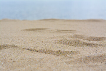 Fototapeta na wymiar Beautiful beach with golden sand near sea, closeup view.