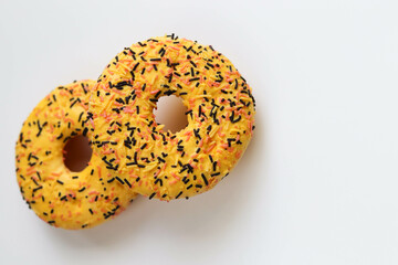 sweet dessert. round donuts with yellow icing isolated on white background and raspberries