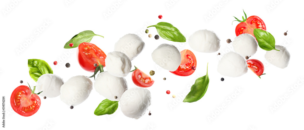 Wall mural mozzarella cheese balls, tomatoes, basil leaves and peppercorns for caprese salad flying on white ba