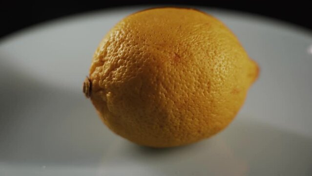 Fresh spinning lemons on black background.Lemon Tasty lemons isolate on the black background close up 4k