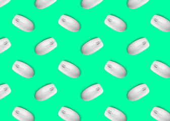 Many white computer mouses on bright green background, flat lay. Seamless pattern design