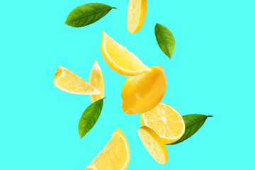 Fresh ripe lemons and green leaves on cyan background