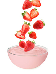Many fresh red strawberries falling into glass bowl of yogurt on white background