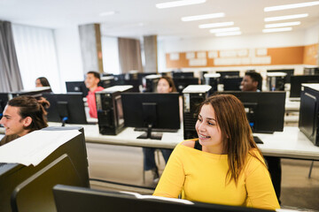 Young students using computers inside technology class at school room - Soft focus on right girl eye
